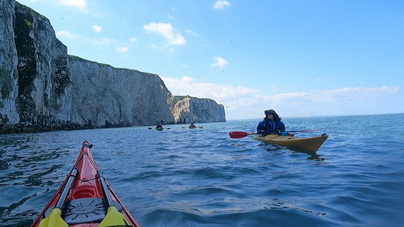 Photograph of a red sea kayak on the sea.